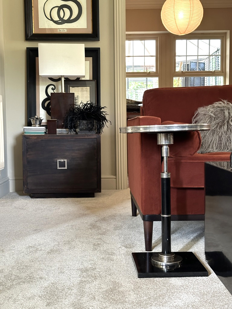 warm neutral beige living room carpet with orange sofa